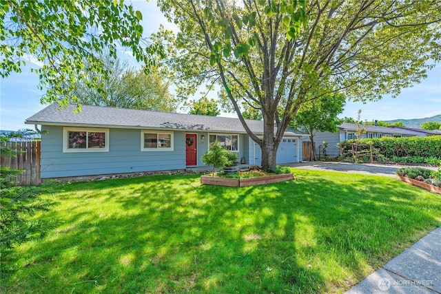 single story home featuring a garage, fence, a front yard, a shingled roof, and driveway