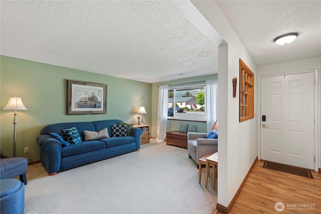 living room featuring baseboards and a textured ceiling