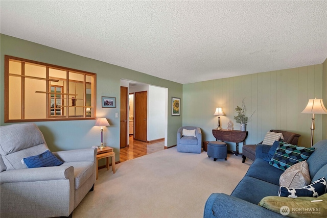 living area featuring carpet floors and a textured ceiling