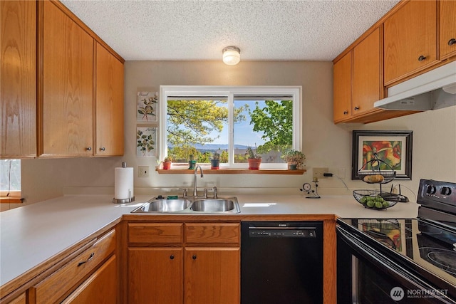 kitchen featuring a textured ceiling, a sink, light countertops, black appliances, and under cabinet range hood