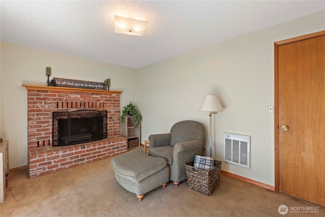 carpeted living area featuring a fireplace, a textured ceiling, and visible vents