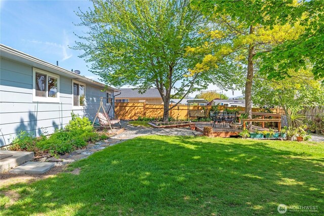 view of yard featuring a fenced backyard and a deck