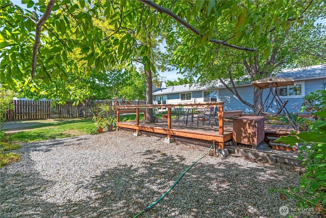 view of yard with a fenced backyard and a deck