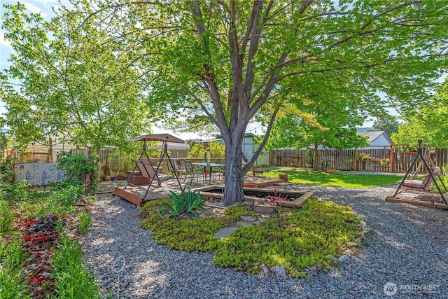 view of yard with a fenced backyard and a deck