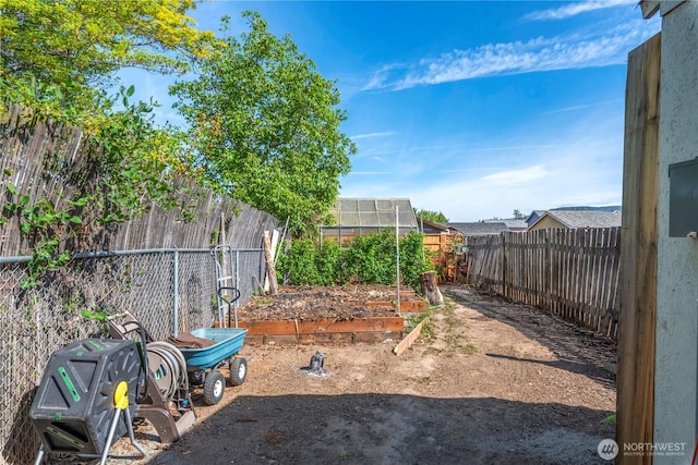 view of yard featuring an exterior structure, an outbuilding, and a fenced backyard