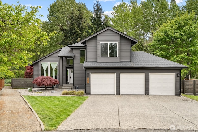 6411 86th Street Ct E, Puyallup, WA 98371 - view of front of home with fence, a shingled roof, and concrete driveway