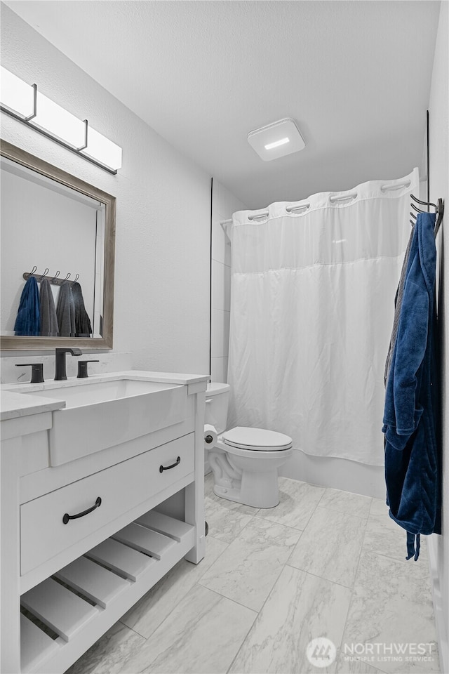 6411 86th Street Ct E, Puyallup, WA 98371 - bathroom featuring vanity, shower / tub combo with curtain, toilet, and marble finish floor