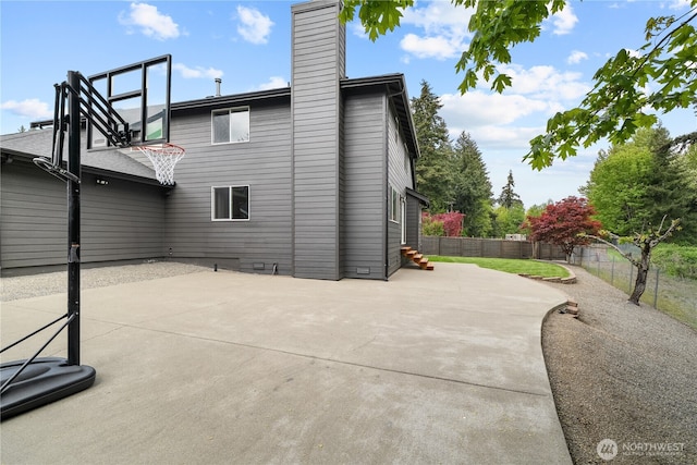 6411 86th Street Ct E, Puyallup, WA 98371 - back of property with a patio, fence, and a chimney