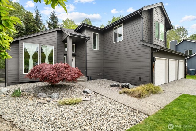 6411 86th Street Ct E, Puyallup, WA 98371 - view of front of house with concrete driveway and an attached garage