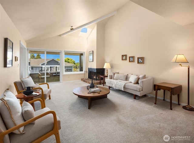 living area with carpet flooring, a warm lit fireplace, baseboards, and high vaulted ceiling