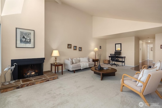 living room with a fireplace, high vaulted ceiling, and carpet