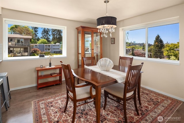 dining area with baseboards and a notable chandelier