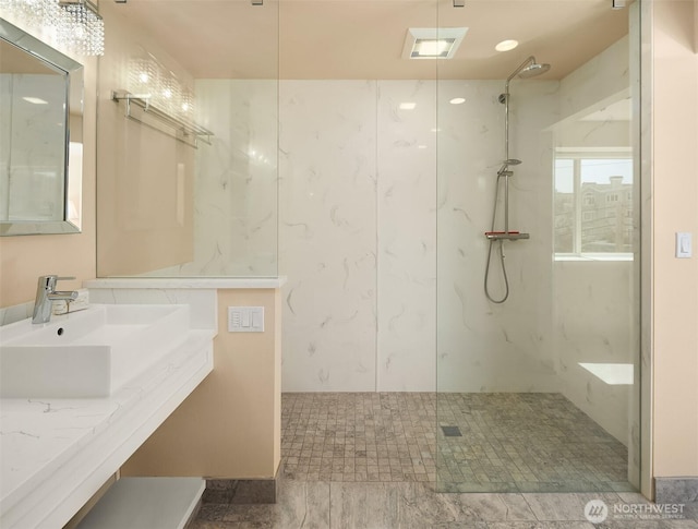 full bath featuring visible vents, a marble finish shower, and a sink