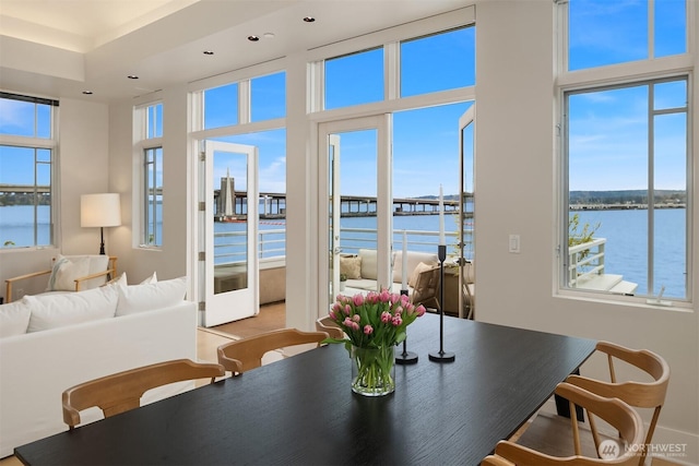 dining space featuring a water view and recessed lighting