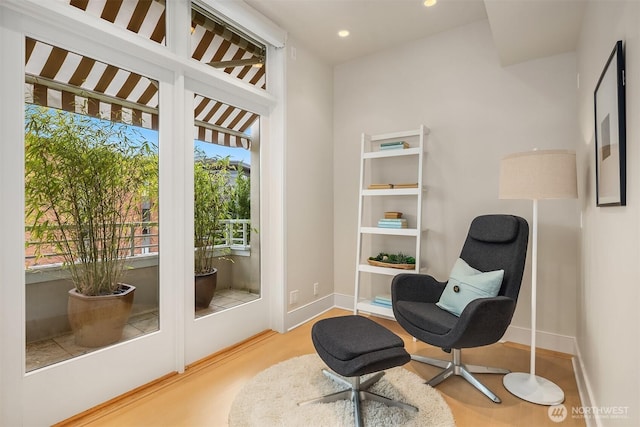 living area with recessed lighting and baseboards