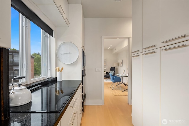 interior space featuring baseboards and wood finished floors