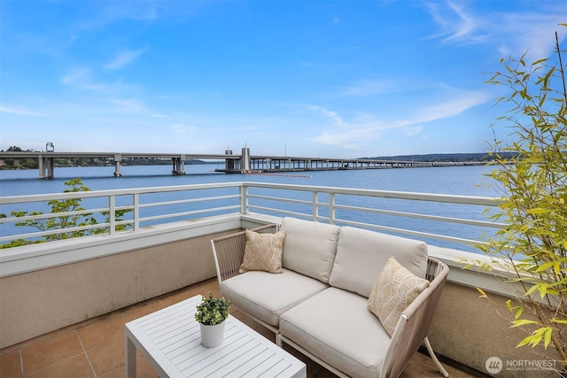 balcony featuring a water view and an outdoor hangout area