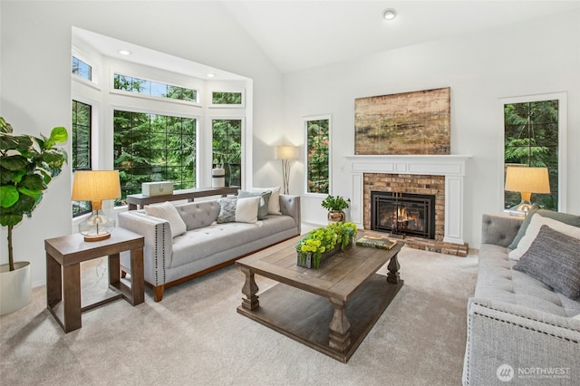 living room with high vaulted ceiling, carpet, a brick fireplace, and recessed lighting