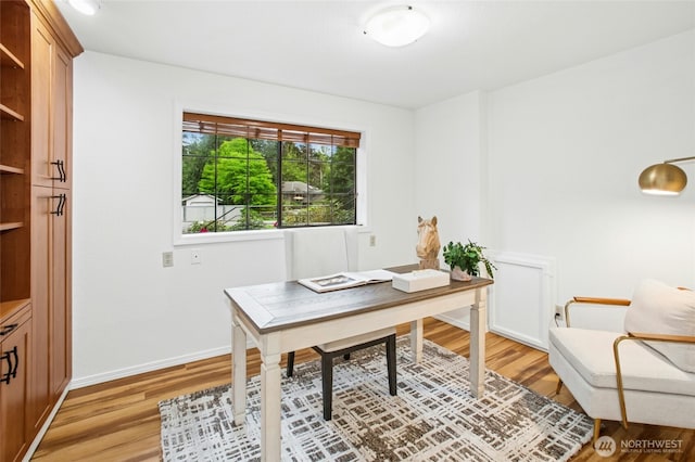 home office with baseboards and light wood-type flooring
