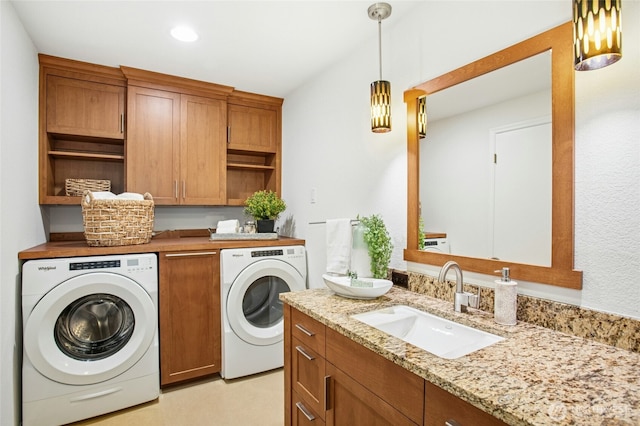 laundry room with washing machine and clothes dryer, recessed lighting, laundry area, and a sink