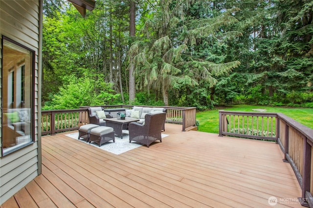 wooden deck featuring a forest view and outdoor lounge area