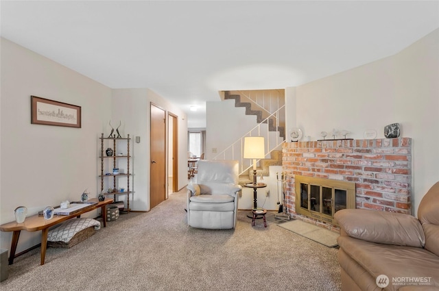 living room featuring stairway, carpet, and a fireplace