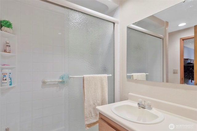 bathroom featuring vanity and a shower stall