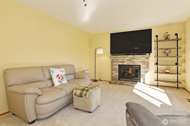 living area with carpet flooring and a fireplace