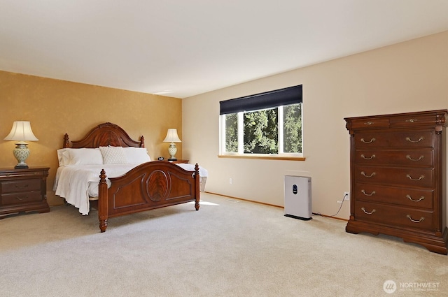 bedroom with baseboards and light carpet