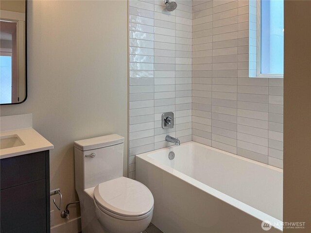 full bathroom featuring plenty of natural light, tub / shower combination, toilet, and vanity