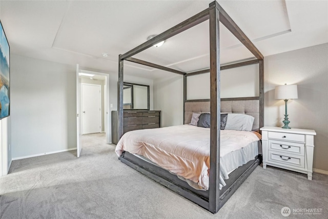 bedroom with baseboards and carpet