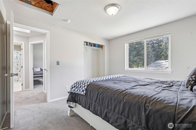 bedroom with a closet, baseboards, and carpet flooring