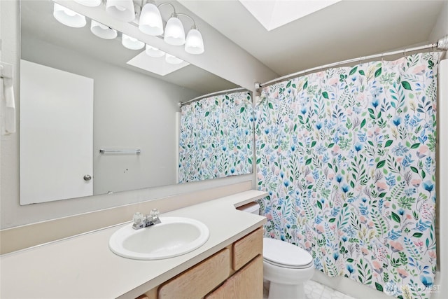 bathroom with vanity, toilet, a skylight, and a shower with curtain