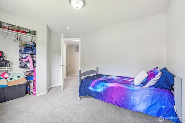 carpeted bedroom featuring baseboards