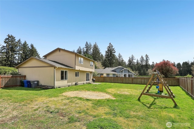 exterior space with a fenced backyard and a playground