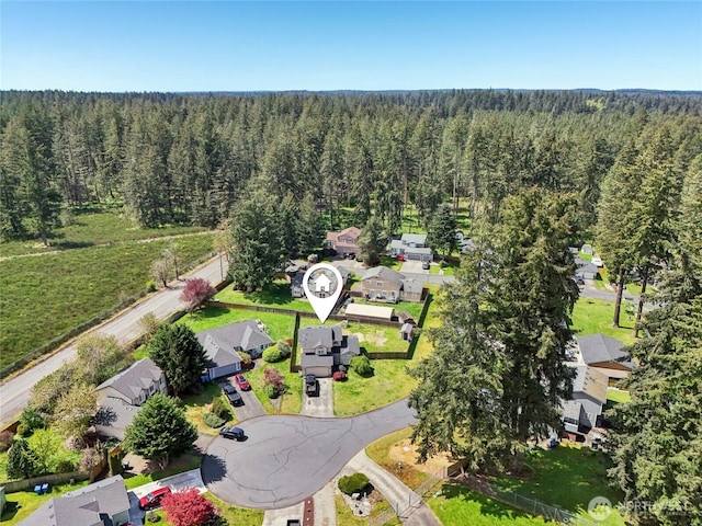 drone / aerial view featuring a view of trees and a residential view