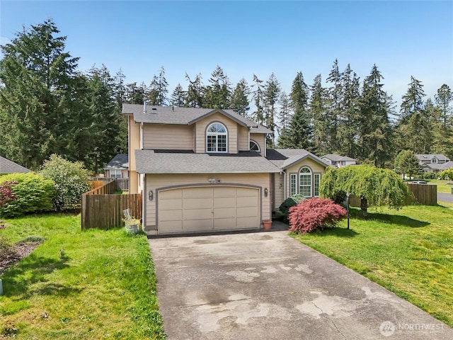 tri-level home featuring concrete driveway, an attached garage, fence, and a front lawn