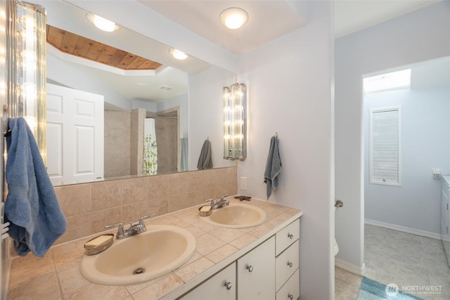 2877N Nugent Rd Unit M4, Lummi Island, WA 98262 - bathroom with double vanity, backsplash, a shower with curtain, and a tray ceiling