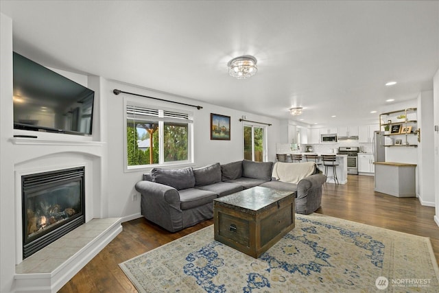 17726 83rd Dr NE, Arlington, WA 98223 - living room with dark wood-type flooring, a tile fireplace, and recessed lighting