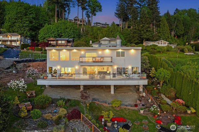 rear view of property featuring a wooden deck and a balcony
