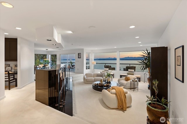 living area featuring recessed lighting and light carpet