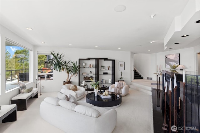 living room with recessed lighting, visible vents, and stairway