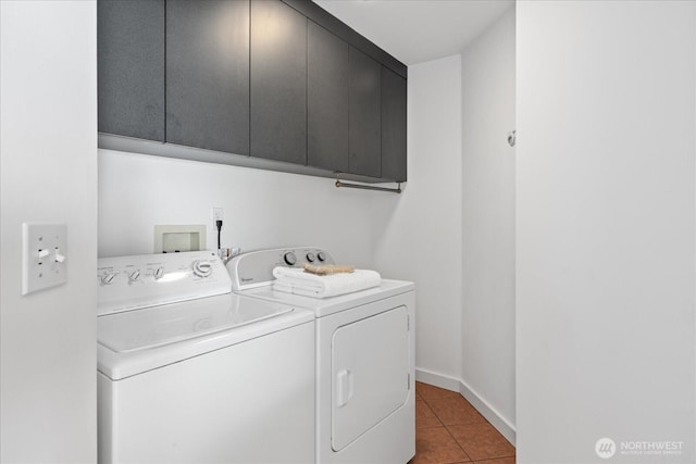 laundry room with separate washer and dryer, cabinet space, baseboards, and light tile patterned flooring