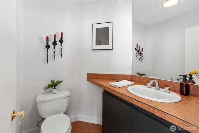 half bath featuring vanity, tile patterned flooring, baseboards, and toilet