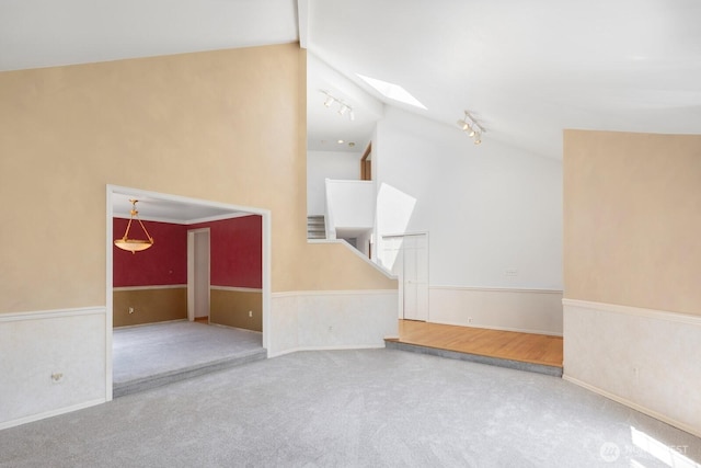 23812 21st Dr SE, Bothell, WA 98021 - interior space with track lighting, a wainscoted wall, and lofted ceiling with skylight