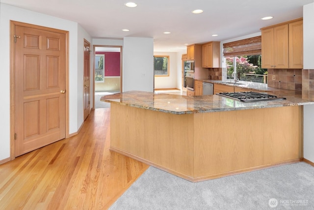 23812 21st Dr SE, Bothell, WA 98021 - kitchen featuring light stone countertops, appliances with stainless steel finishes, a sink, a peninsula, and recessed lighting