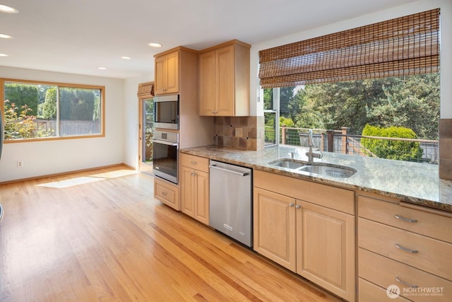 23812 21st Dr SE, Bothell, WA 98021 - kitchen featuring light stone countertops, light wood-type flooring, a sink, light brown cabinets, and stainless steel appliances