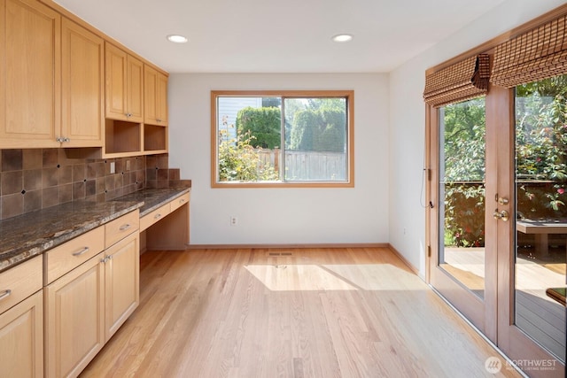 23812 21st Dr SE, Bothell, WA 98021 - kitchen with decorative backsplash, plenty of natural light, built in desk, and light wood finished floors