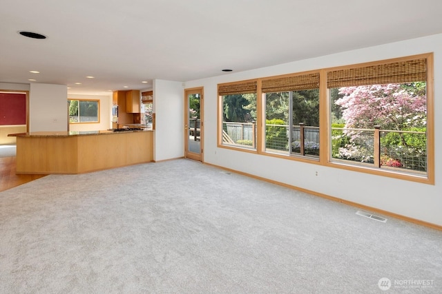 23812 21st Dr SE, Bothell, WA 98021 - unfurnished living room featuring recessed lighting, baseboards, visible vents, and light carpet
