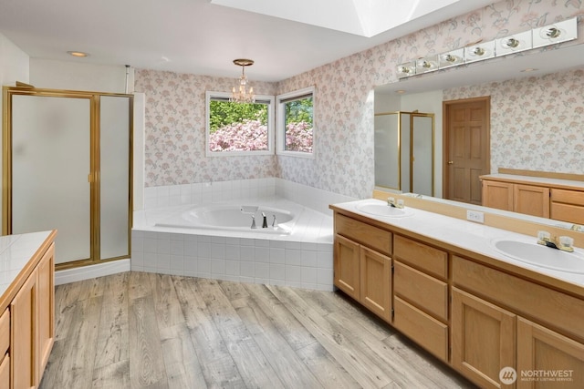 23812 21st Dr SE, Bothell, WA 98021 - bathroom featuring a bath, a skylight, a shower stall, a sink, and wallpapered walls